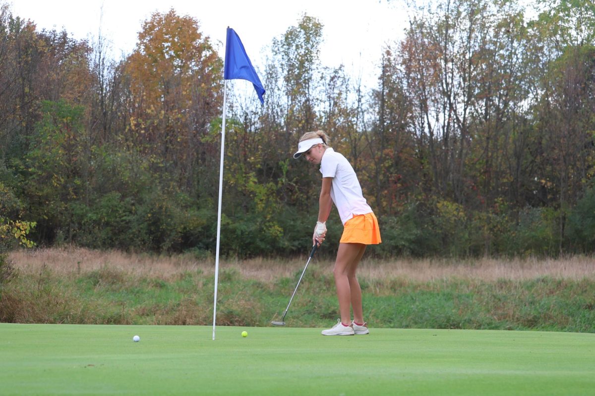 Hitting the ball, senior Cassandra Harris uses her putter. On Sept. 24, the Fenton girls JV golf team played Flushing at Tyrone Hills. 