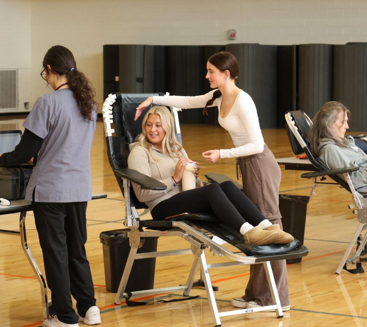 Smiling, junior Chloe Muntin gets ready to donate blood. On Sept. 5, NHS hosted its first annual blood drive. 