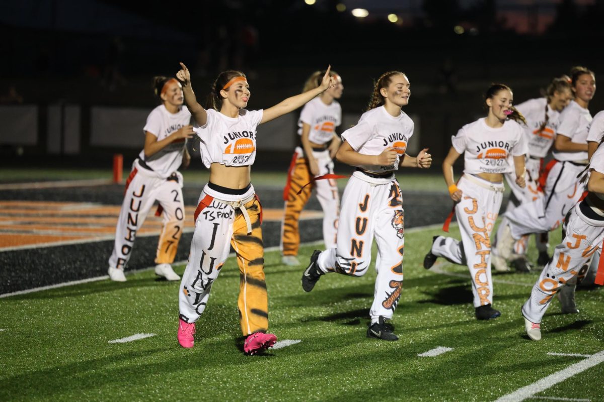 Celebrating, junior Gwen Ayers and her team gets a touchdown. On Sept. 15, juniors and seniors go head to head in a Powderpuff game.