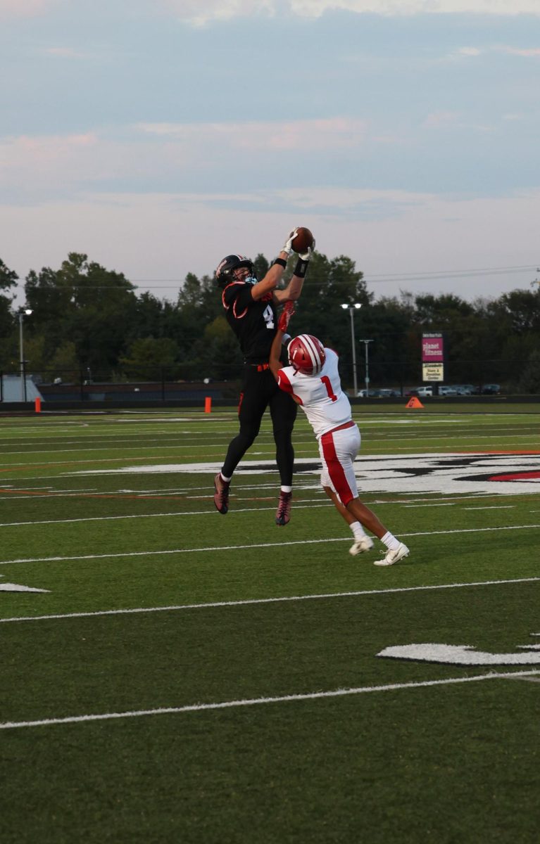 Catching, senior Rory Sheil grabs the ball. On Sept. 19, the Fenton varsity football team went against Swartz Creek and won 49-0.