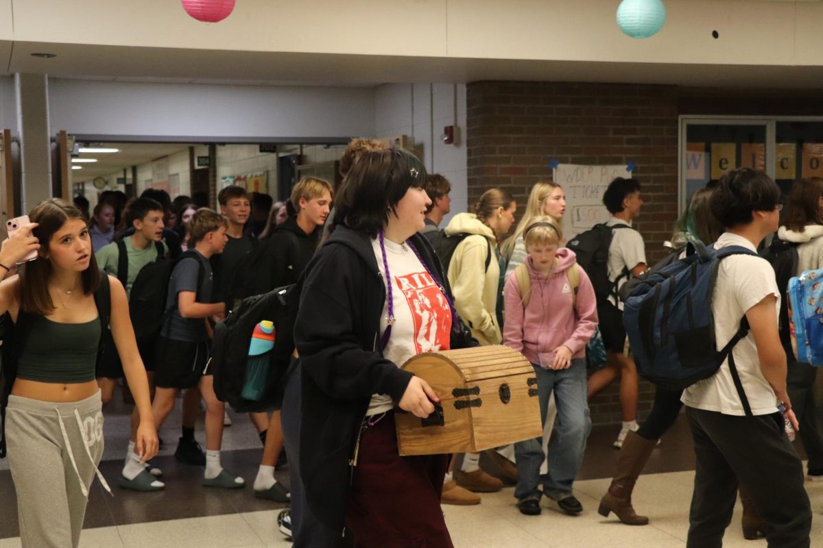 Walking, Senior Lucy Billings is carrying a chest as a backpack. On Sept. 17 FHS had a homecoming spirit day, anything but a backpack.