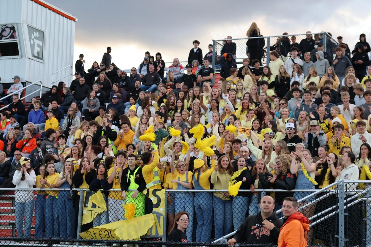 Cheering, fhs student section celebrating at the varsity football game  on sept. 5 fhs played Haslett and lost 15-14.  