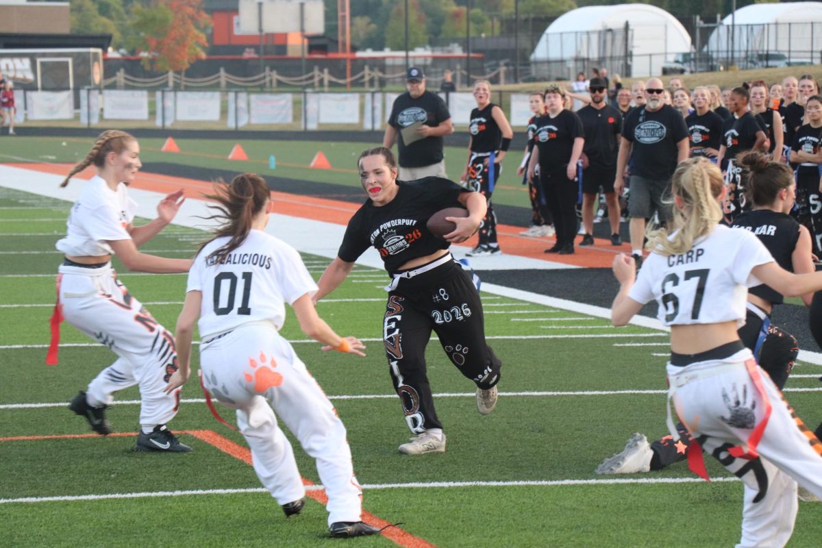 Running, senior Ally Turkowski runs the ball down the sideline for a first down. On Sept. 15, there was a junior and senior Powderpuff game.