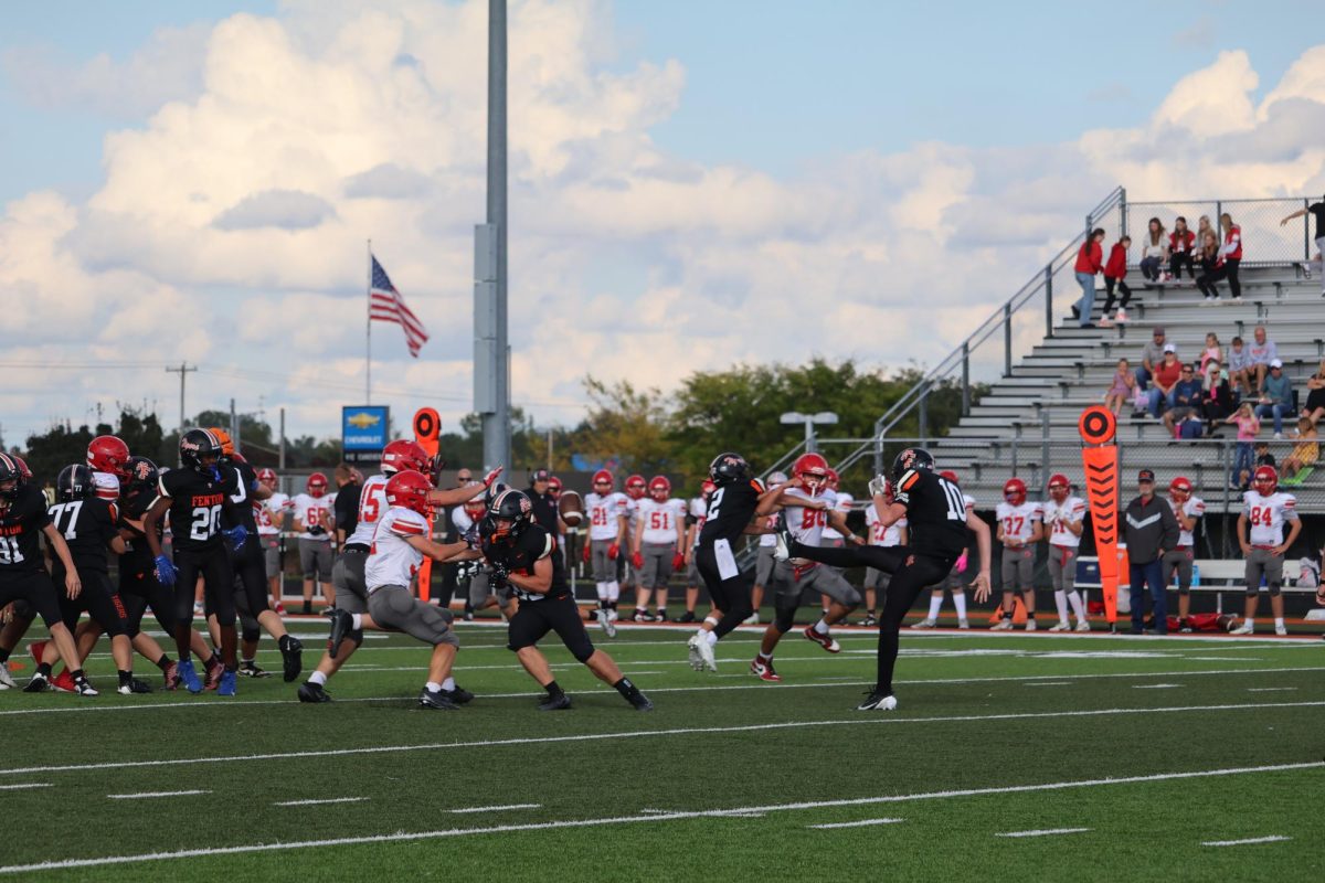 Kicking the ball, freshman Maddox Moore kicks it down the field to his receiver, Weston Timrowski, on Sept. 25, the boys' freshman football team vs Holly and lost 32-2 
