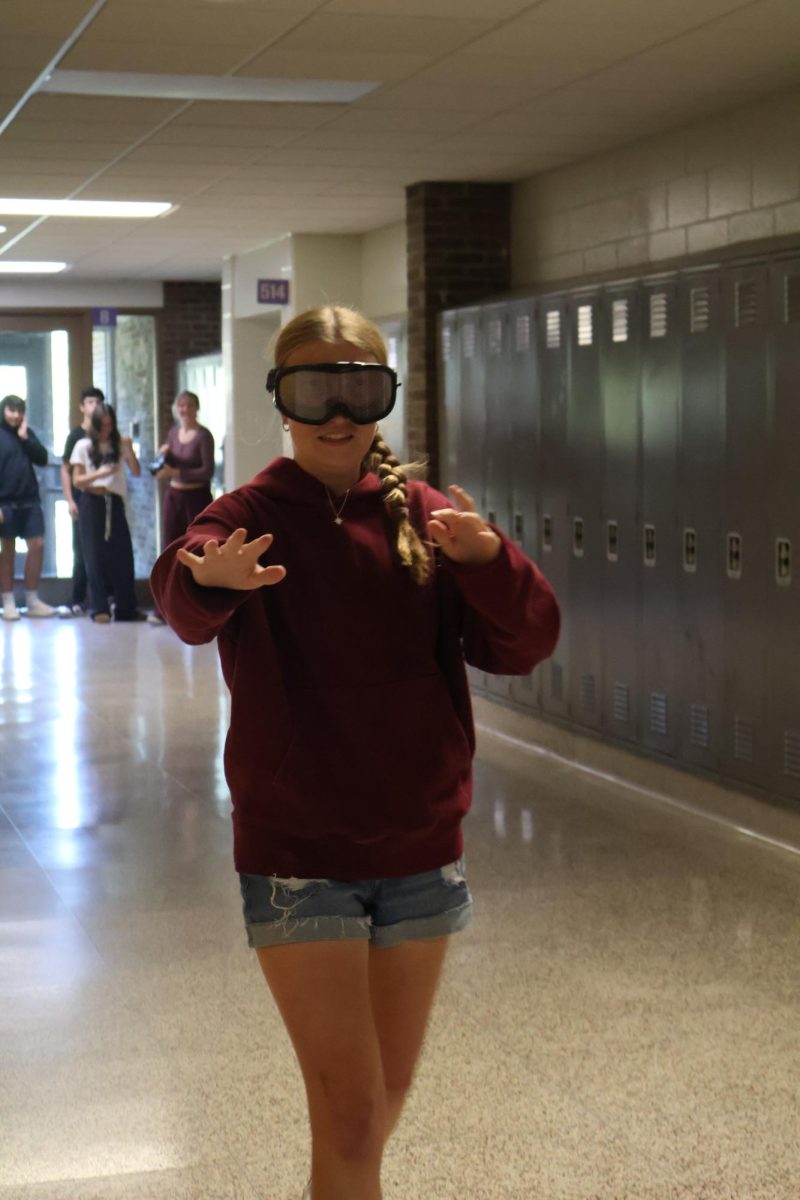 Walking, junior Lillian Reynolds is trying to balance herself as they test out drunk goggles. On Sept. 26, the science teacher, Matt Sullivan, did a lab to test out drunk goggles to see how they would feel.