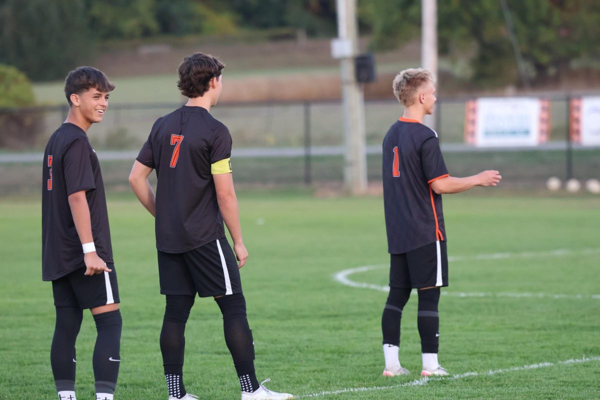 Talking, senior Dillon Hamilton, junior Dakota Lawrence, and freshman Jagger Gomez speaking to one another. On Sept. 17, the Fenton varsity soccer team went up against Kearsley and won 8-0.