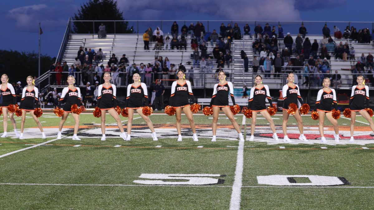 Taking the field, the Fenton varsity dance team prepares to begin their dance. On Sept. 5, the dance team performed at halftime of the varsity football game. 