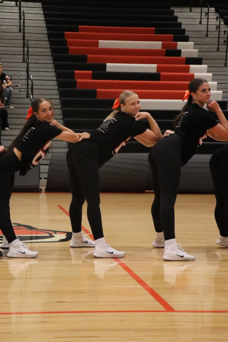 Smiling Junior Kyla Moore, Senior Sanibel Stack, and Karley Russell. On Sept 19, they were dancing at the homecoming pep rally.
