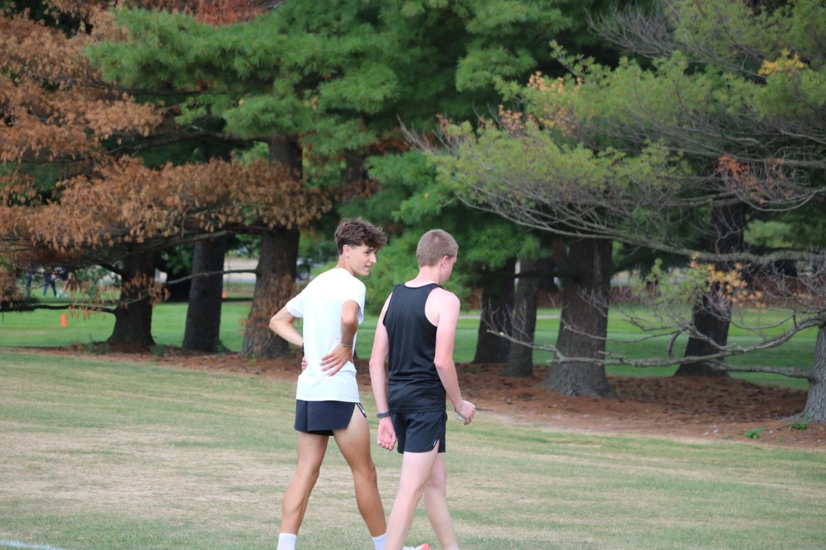 Post run junior Jackson Defina encourages sophomore Brandon Perantoni after his race. On Sept. 12, the Fenton cross country team placed fourth at the MSU Invitational meet.
