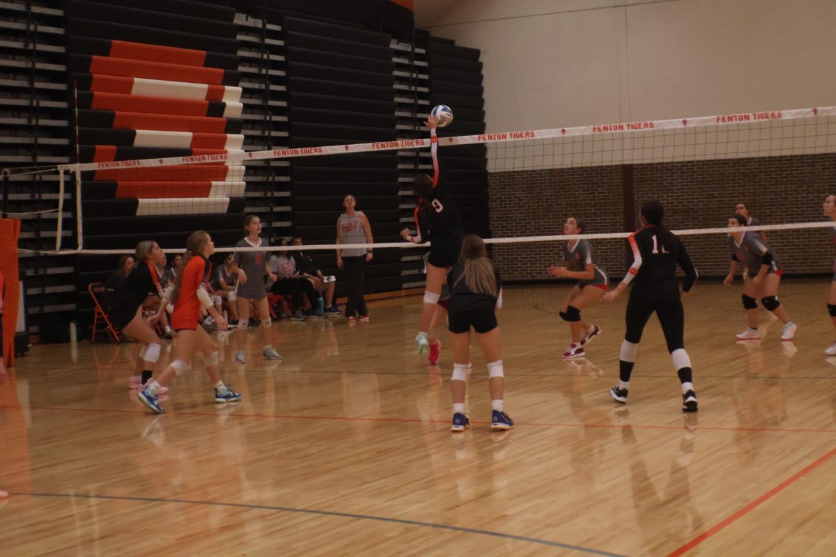 Attacking the ball, freshmen Lindsey Larner hit the ball over to Holly. On Sept. 29 freshmen volleyball team played Holly in a strong win.