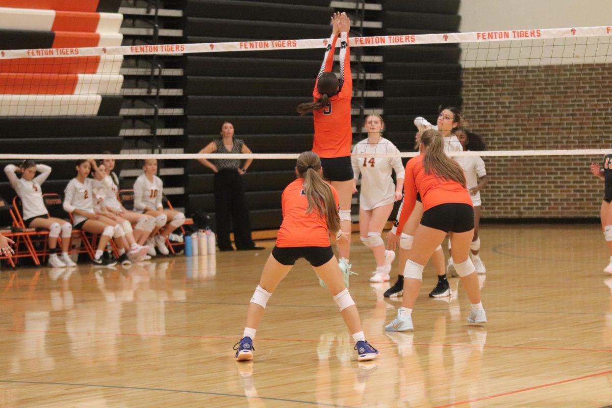 Jumping for the ball, freshmen Lindsey Larner blocks the hit from Flushing. On Sept. 18, Fenton freshmen volleyball went up against Flushing and they won.