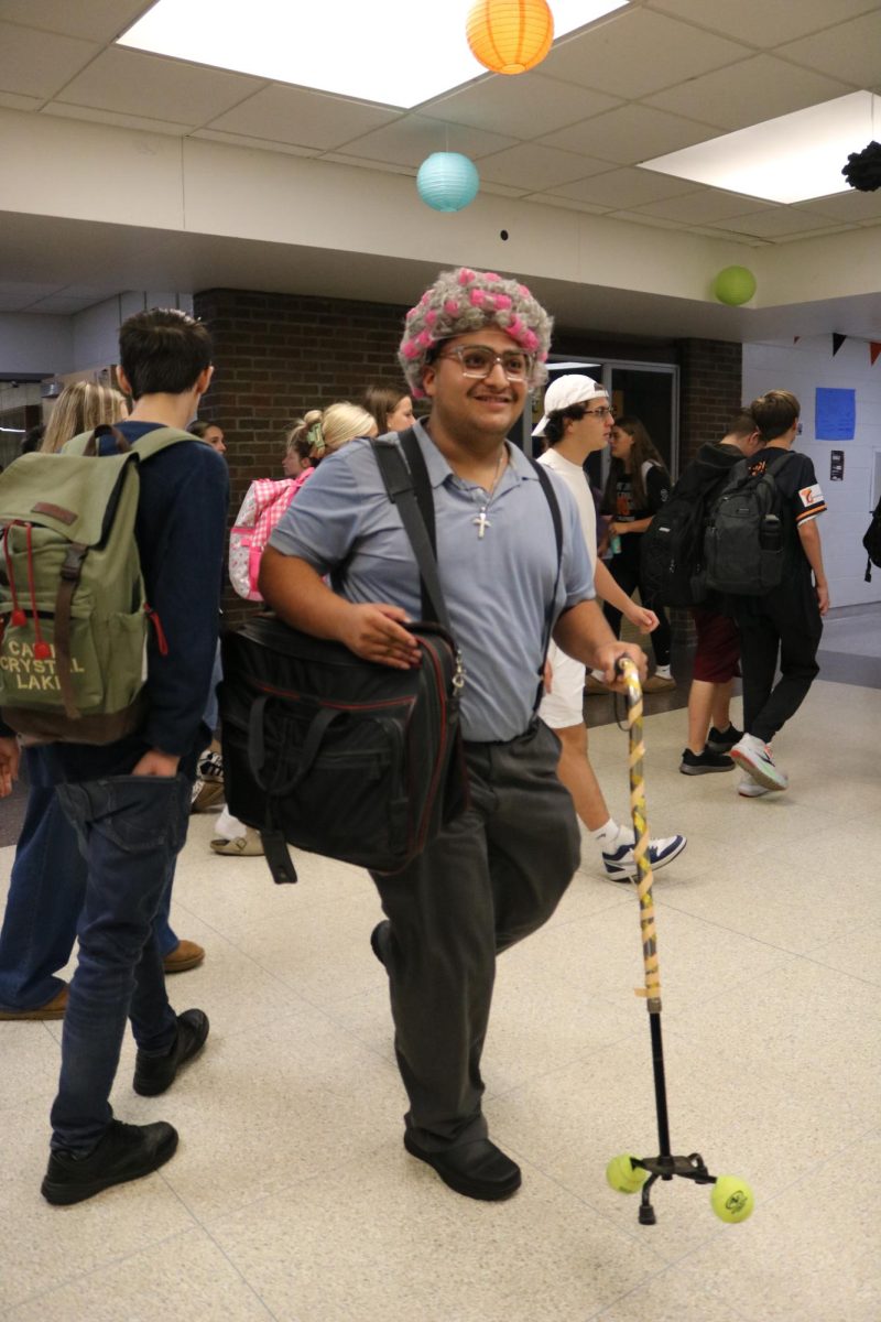 Smiling, senior Eduardo Herrera desses like a elder. On Sept. 18, students participated in the homecoming spirit day.