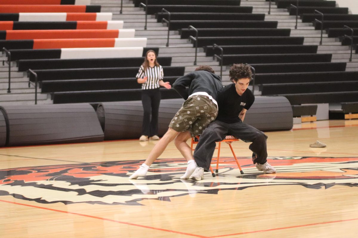 Fighting for the chair,  Junior Zach Pearson and Senior Own Baize are playing musical chairs and fighting for the last round. On Sept. 19, Fenton held a Pep Rally to celebrate before Homecoming and Owen Baize won musical chairs.