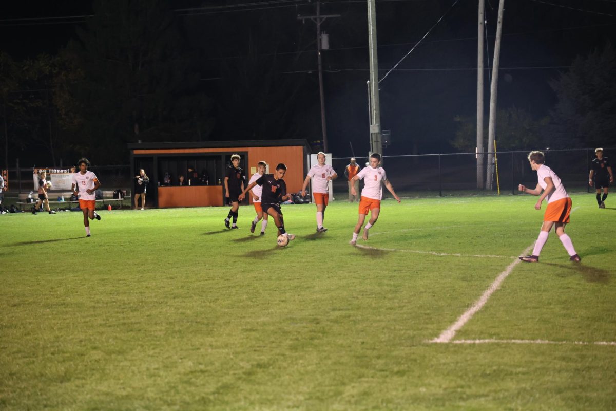 Weaving in and out of defenders, Freshman Jake Ayotte is taking the ball up the field. On Oct. 1, Fenton played Flushing and won 2-1, winning the Flint Metro League championship.