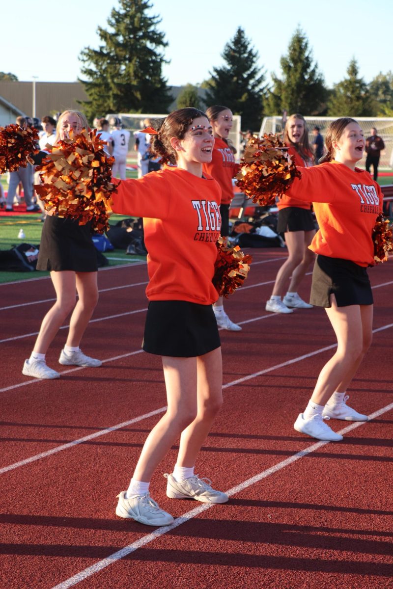 Shouting, freshman Isabella Aimar is cheering to get the parents loud and excited for the JV Fenton football team. On Oct 9, Fenton took a defeat 15-26.