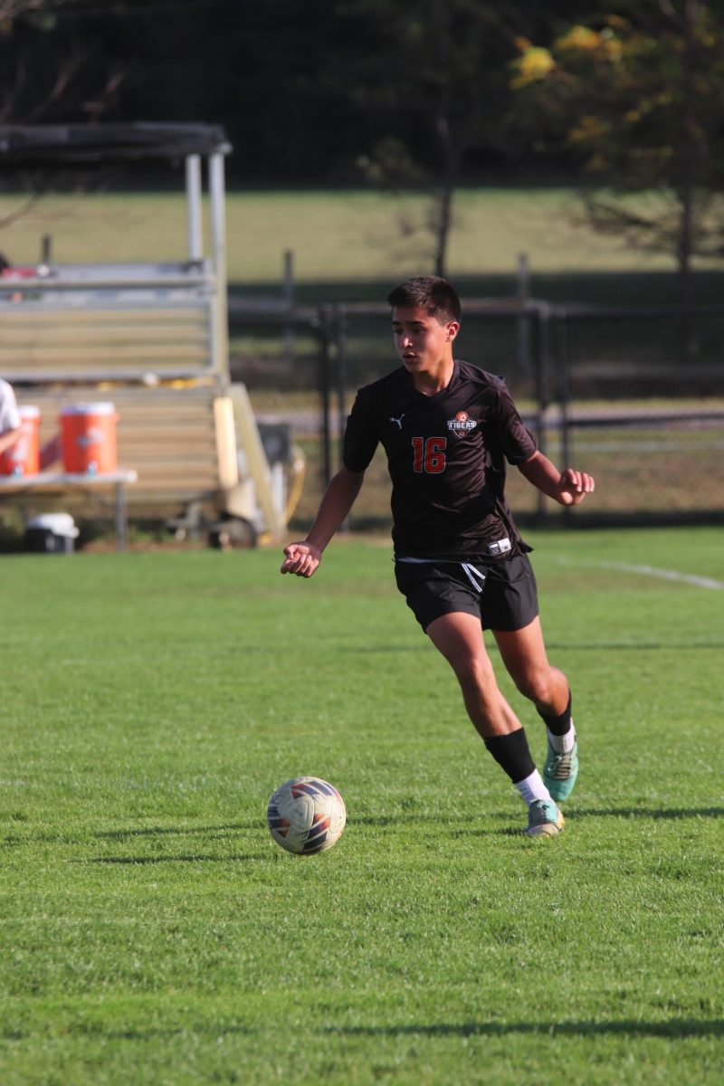 Running towards the goal, freshman Jake Ayott dribbles the ball downfield. On Oct. 6 Fenton Jv soccer played Milford and won 2-0. 
