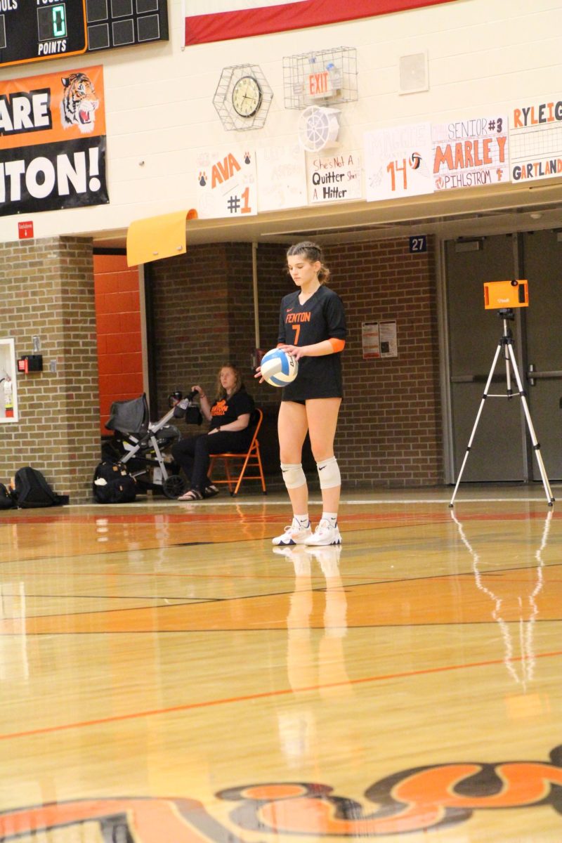 Focusing, senior Eviana Fulton is getting ready to serve for her team. On Oct. 8, Fenton lost to Linden 0 to 3.