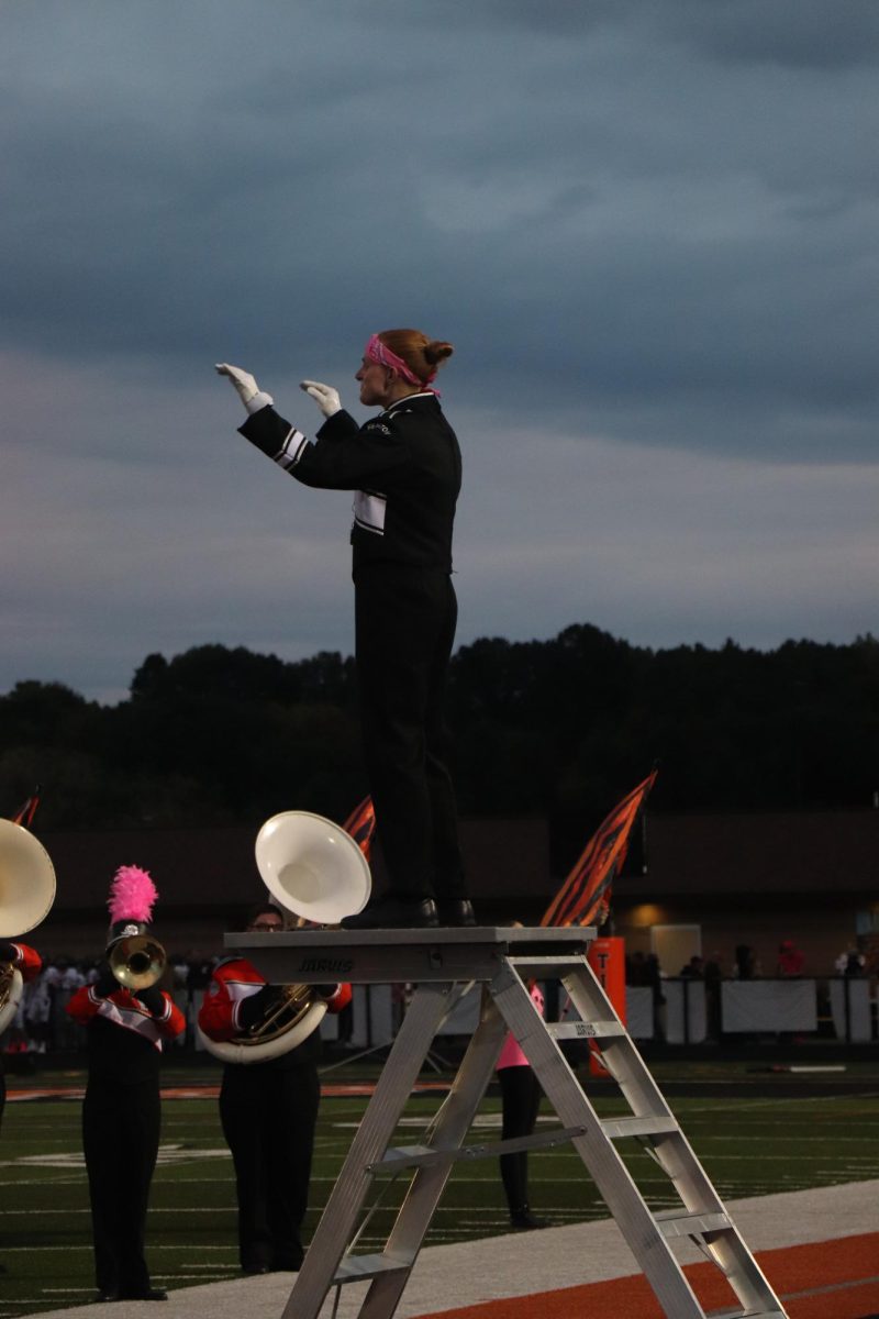 Conducting, The band Ash Holmes and the band are playing Fenton's fight song. On Oct 10 the band played before the home football game 