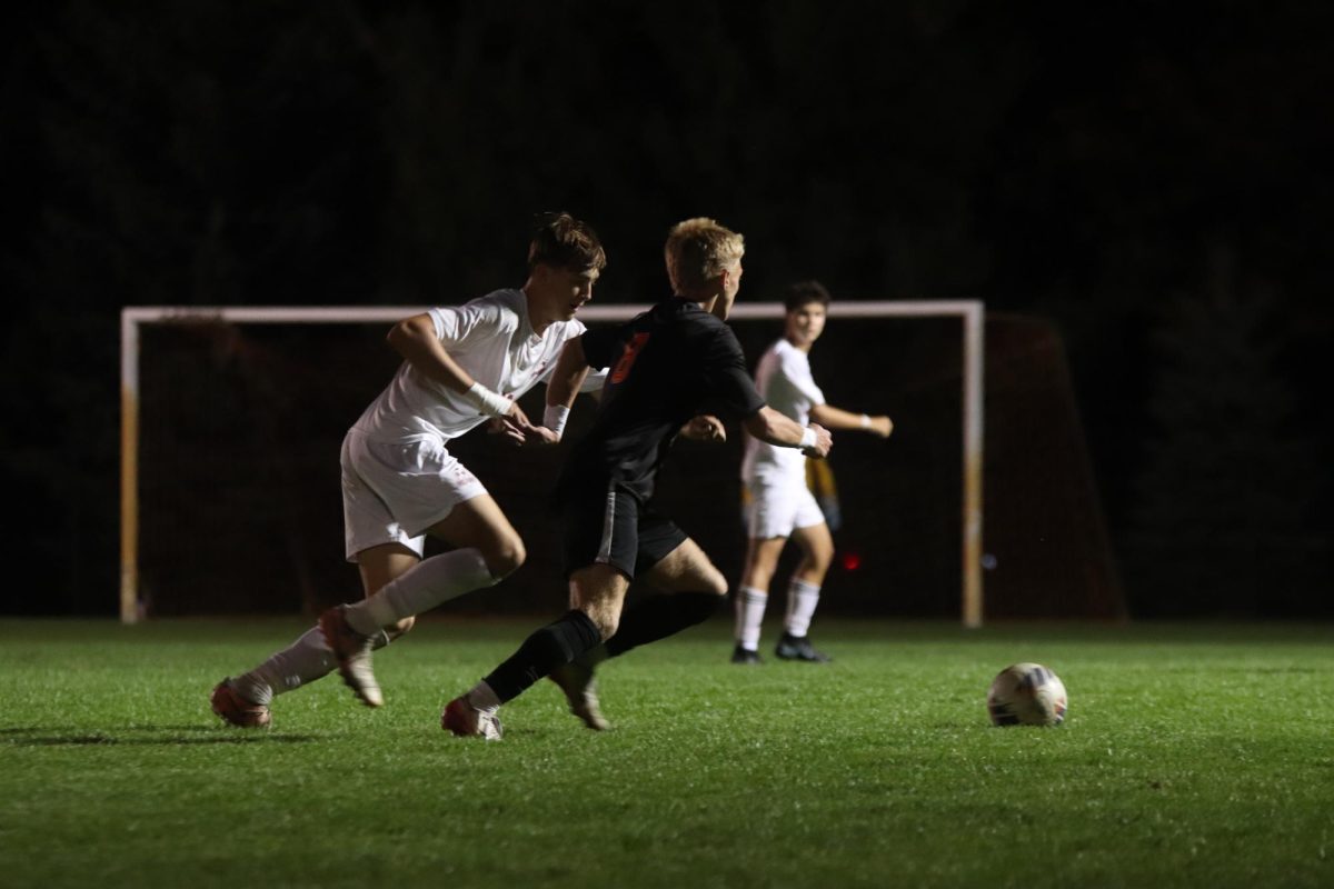 Dribbling towards the goal, junior Dakota Lawrence rushes in the direction of the goalie. On Oct. 6 Fenton varsity soccer played Milford and lost 4-2. 
