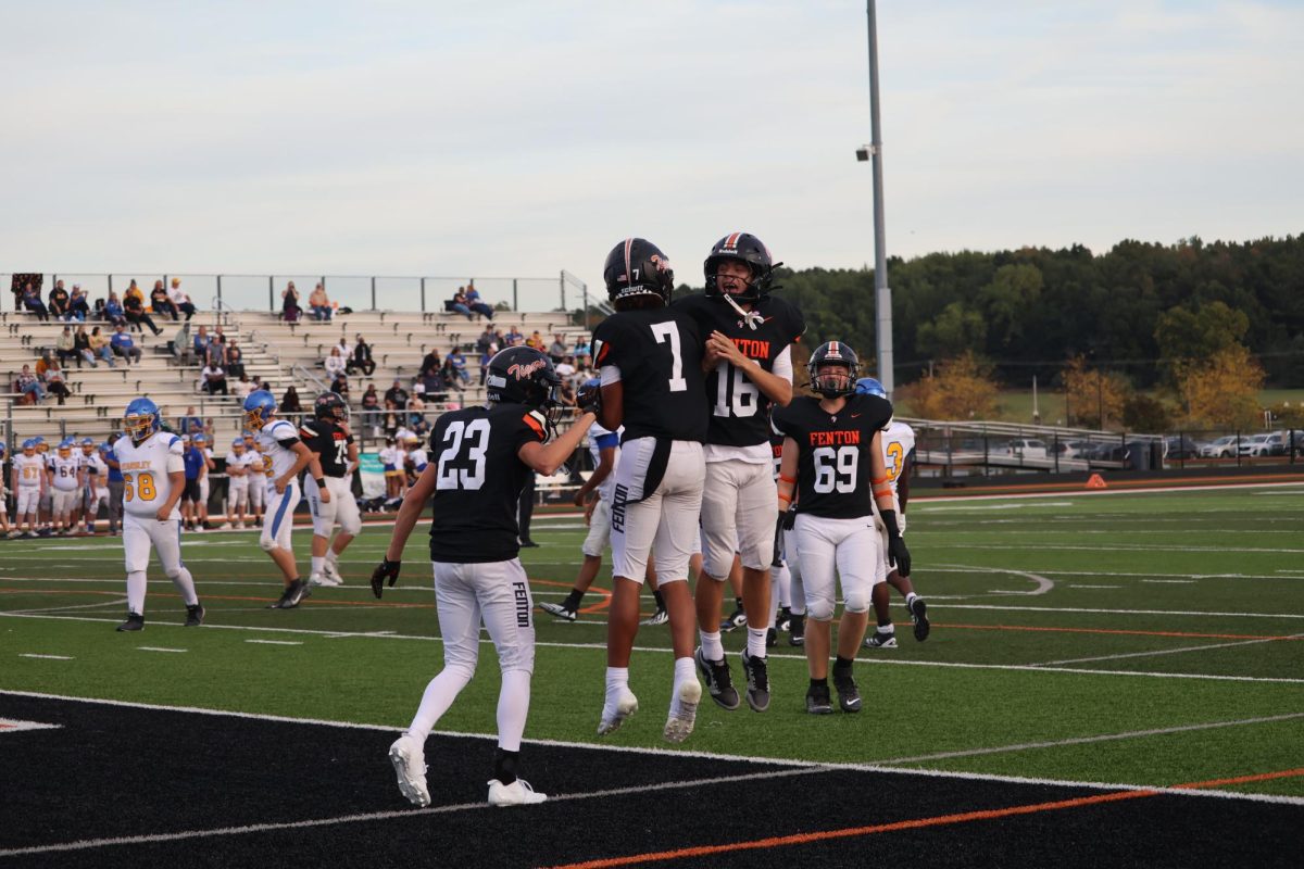 Jumping in celebration, sophomores Trey Hockens and Alec Mock celebrate after a touchdown. On Oct. 2, the JV football team went against Kearsley and won 48-0