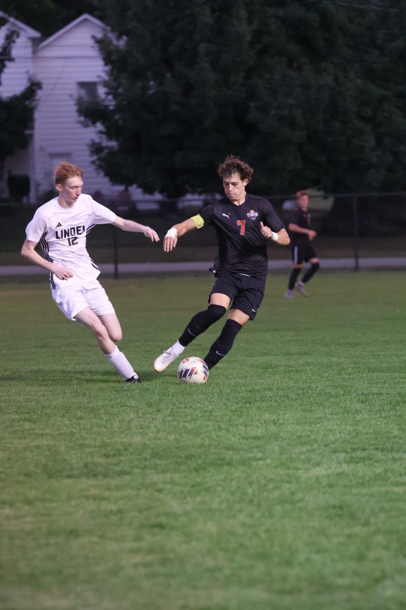 Eyes on the ball, senior Dillon Hamilton advances up the field. On Sept. 22, the FHS boys varsity soccer team went up against Linden High.