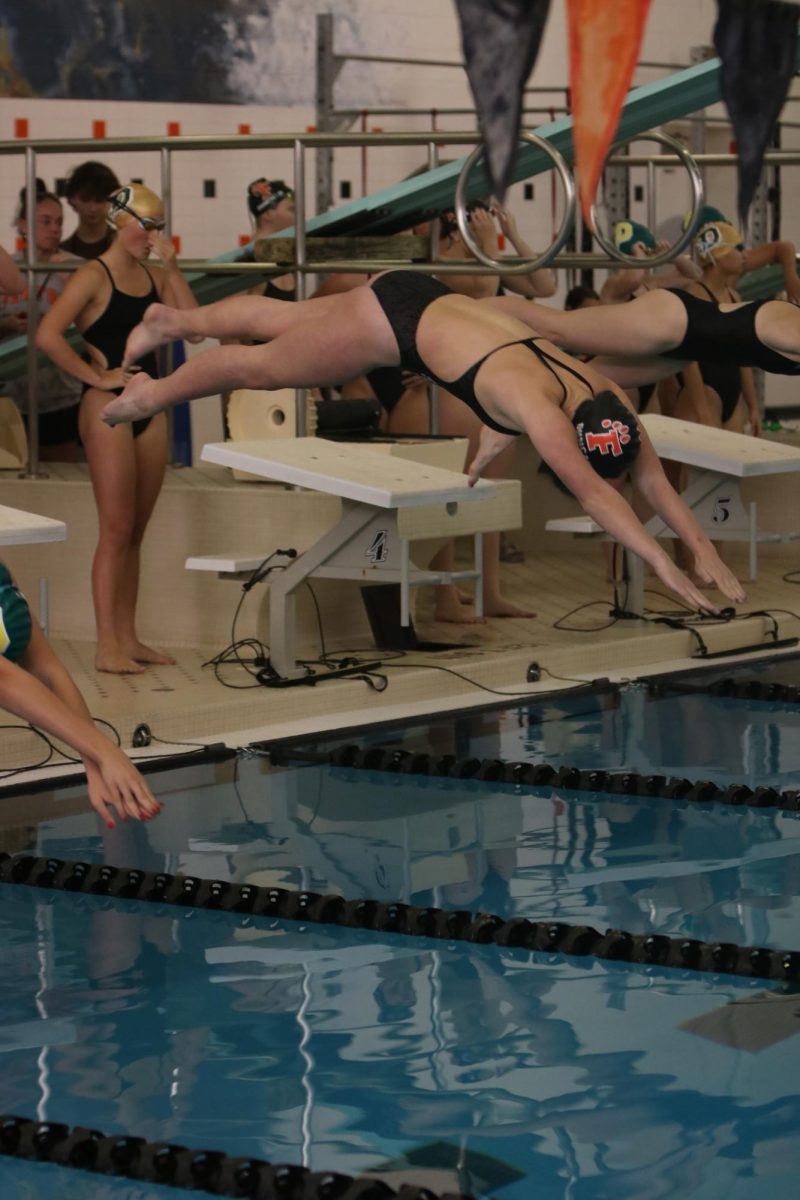 Diving into the pool, sophomore Haley Duncan takes off for her relay race. On Sept. 30, the Girls Swim and Dive team had a meet against Dow High School and won 92-88.