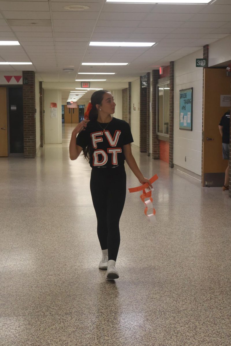 Walking in the halls, senior Sanibel Stack is wears orange and black. On Sept. 19, FHS had a spirit day of the school colors for homecoming. 