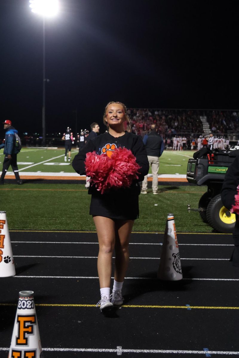 Cheering in front of an audience, junior Marissa Miller performs for the football game. On Oct. 10, the FHS football team went up against Linden and won 47-41. 