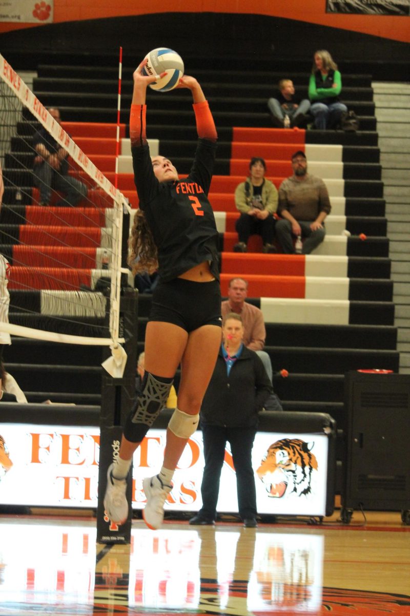 Setting the ball, senior Eva Long is playing with her teammates. On Oct. 15, the FHS varsity volleyball team played Swartz Creek High School, winning 3-0.

