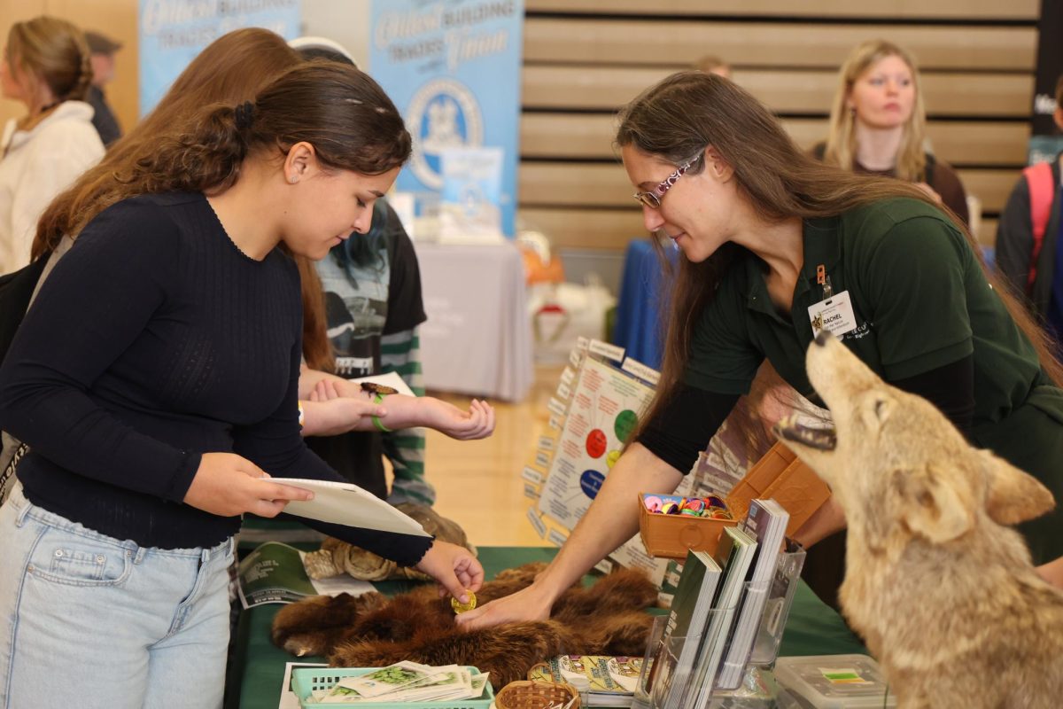 Petting a fur pelt, junior Isabelle Ice talks with a conservationist. On Nov. 6, FHS held a College Career Day. 

