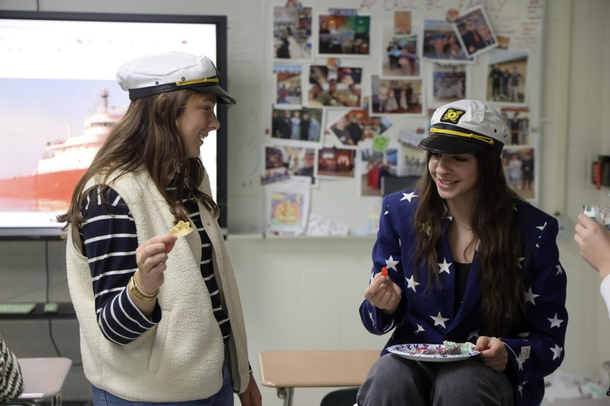Laughing with each other, seniors Grace Perry and Karley Russell celebrate the 50th anniversary of the Edmund Fitzgerald. On Nov. 10, Renae Muzer’s class honored the deaths of the sailors.
