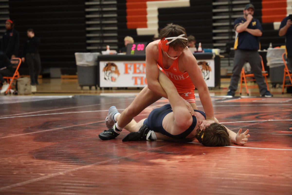 Pinning to the mat, freshman Gage Turnbloom wrestles his opponent. On Dec 3, Fenton wrestling meets in the gym for a quad.