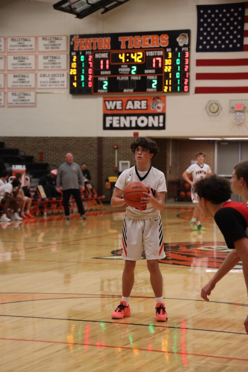 Preparing to shoot the ball, freshman Andrew Smith shoots a free throw. On Dec 11, the freshman boys basketball team played Swartz Creek and lost 33-57.