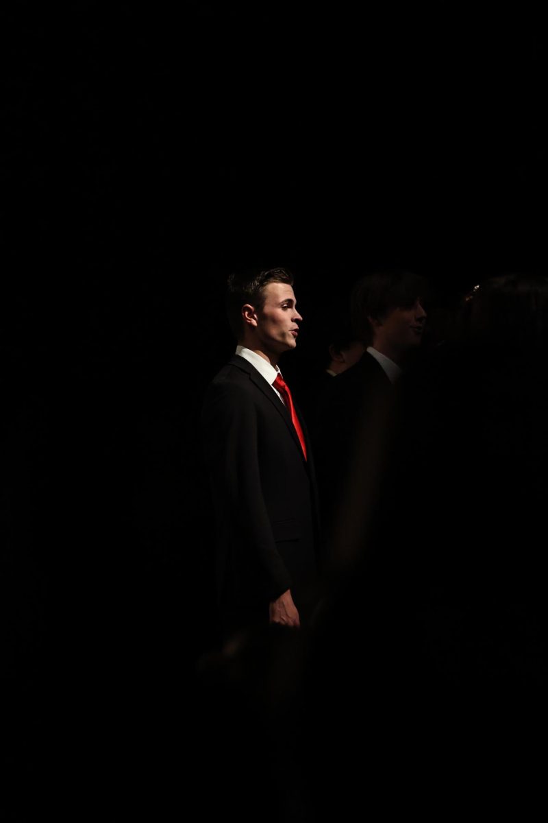 Singing towards the crowd, senior Joe Wright participates with his fellow Ambassadors. On Dec. 4, the Fenton Choir and Ambassador's group sing in the auditorium. 