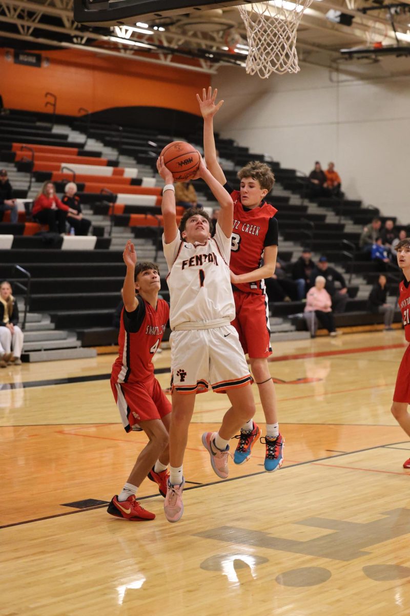 Looking at the net, sophomore Brady Pierson shoots for the basket. On Dec. 11, the JV boys basketball team played Swartz Creek and lost 44-52.
