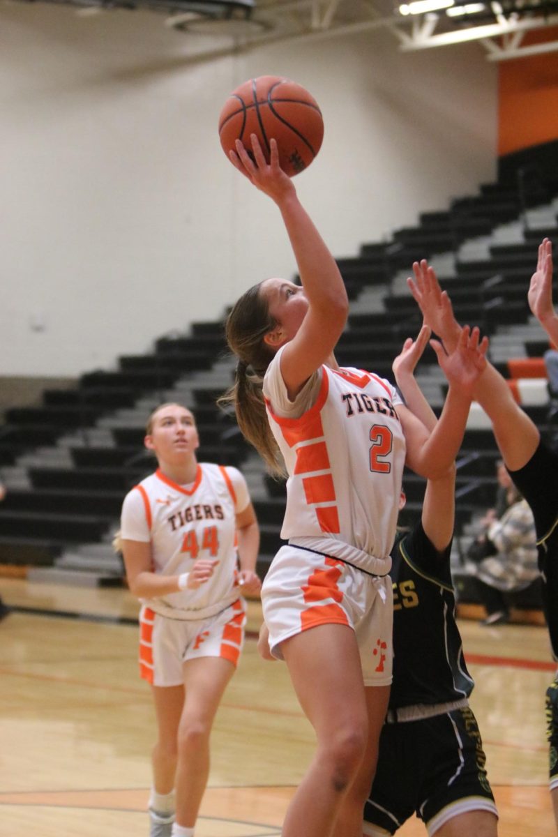 Shooting the ball, junior Madison Eltringham attempts to make a basket. On Dec. 16, the Varsity Girls had a game against Groves and lost 45-103.