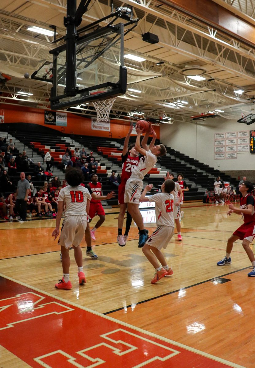 Shooting the ball, freshman Ryker Cross attempts to make a shot. On Dec. 11, the Freshmen Basketball team goes up against Swartz Creek. 
