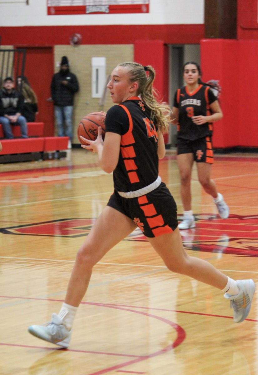 Heading to the basket, junior Lucy Weber gets ready to shoot the ball. On Dec. 12, the varsity girls had a game against Swartz Creek and won 47-30.
