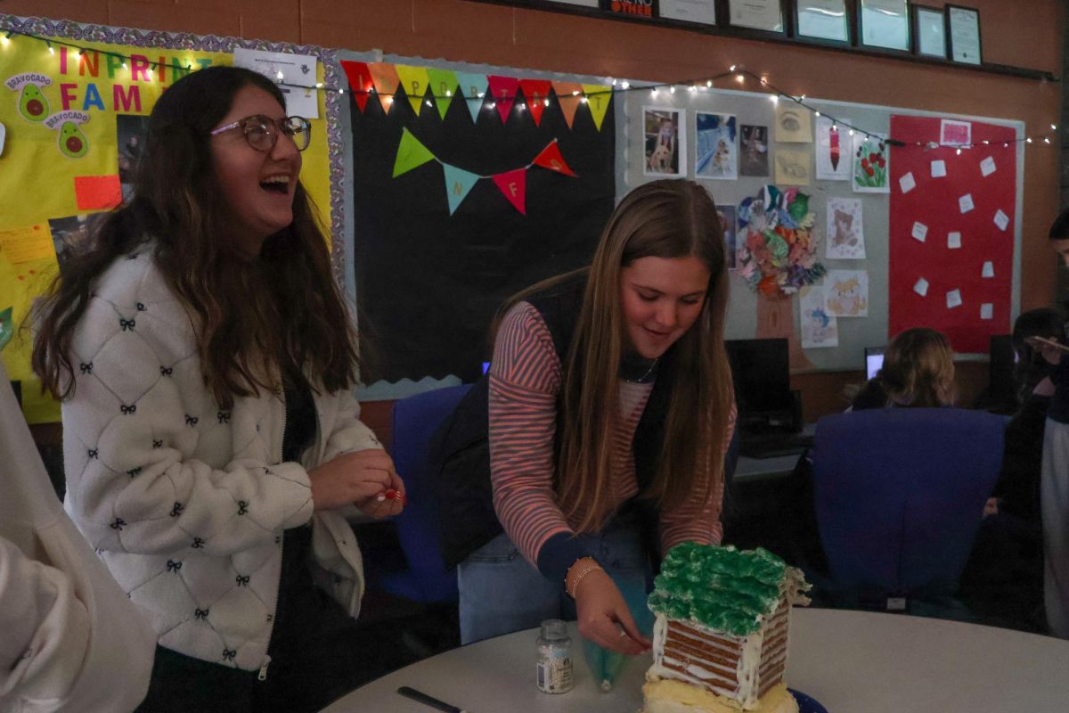 Preparing for the contest, senior Hayley Jensen and Haley Eltringham participate in a bake-off. On Dec. 12, the Fentonian Yearbook staff had a bake-off in honor of the holiday season.