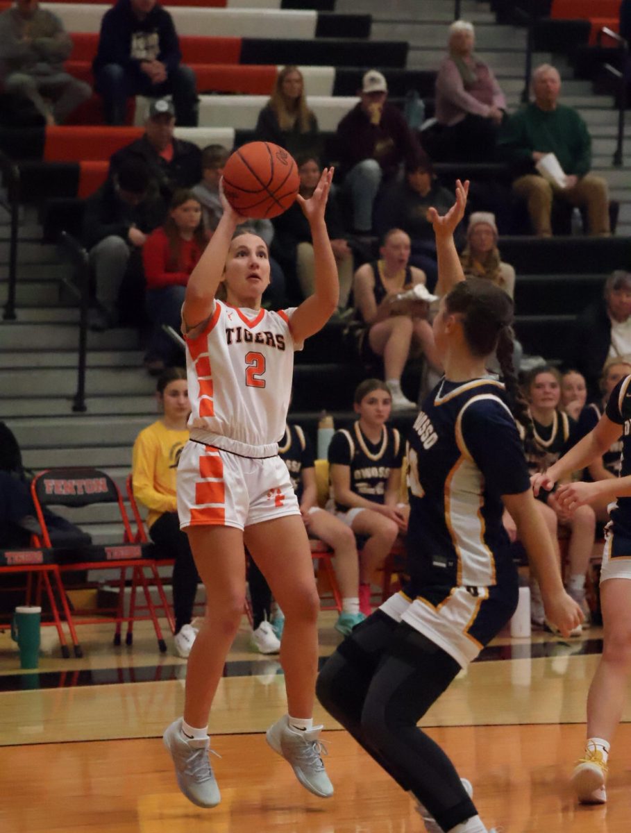Shooting the ball, junior Madison Eltringham attempts to make a shot. On Dec. 9, the varsity girls basketball team goes up against Owosso, winning 47-43.