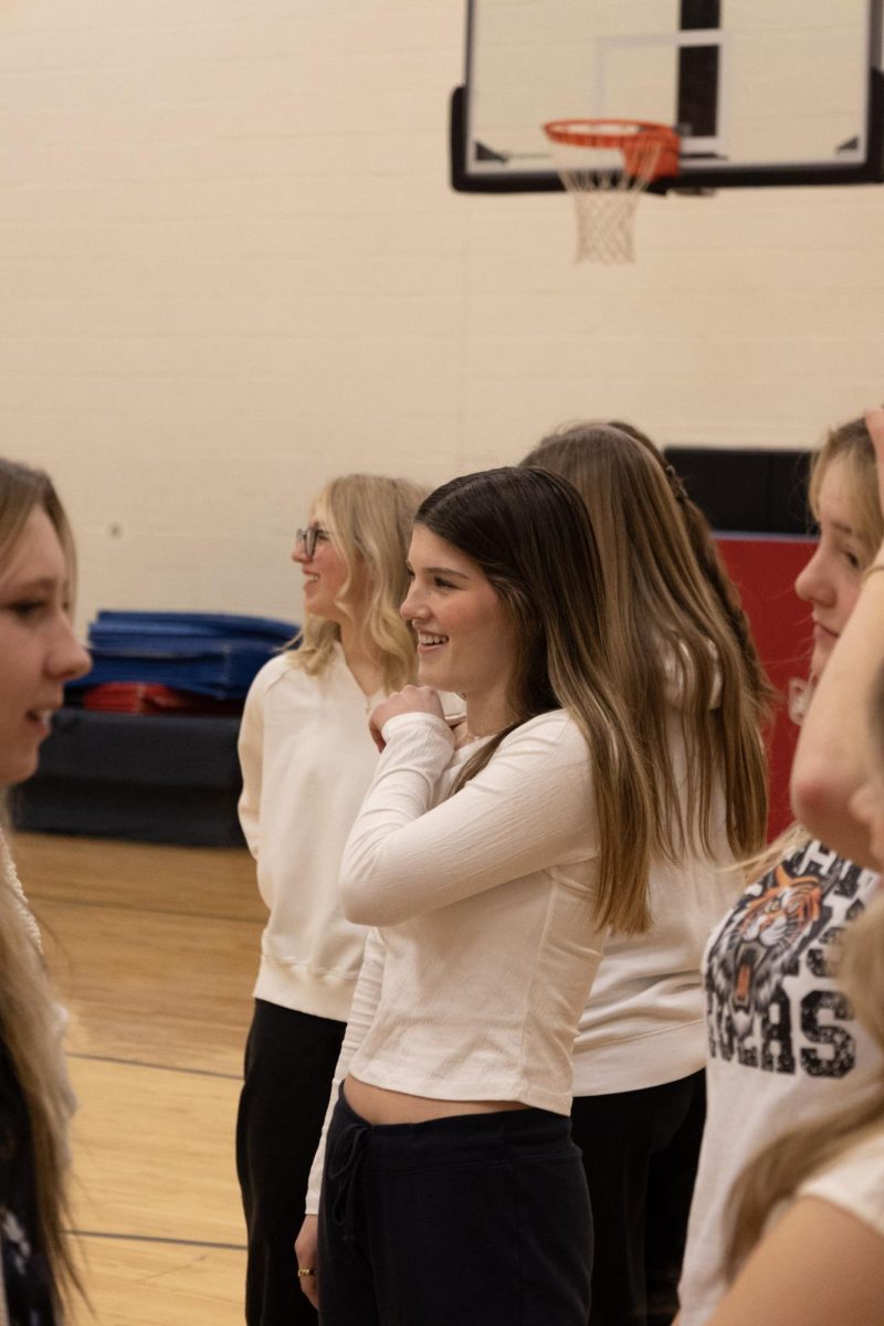 Laughing with her friends, senior Eviana Fulton smiles. On Jan. 6, club photos were taken for the Fentonian. 
