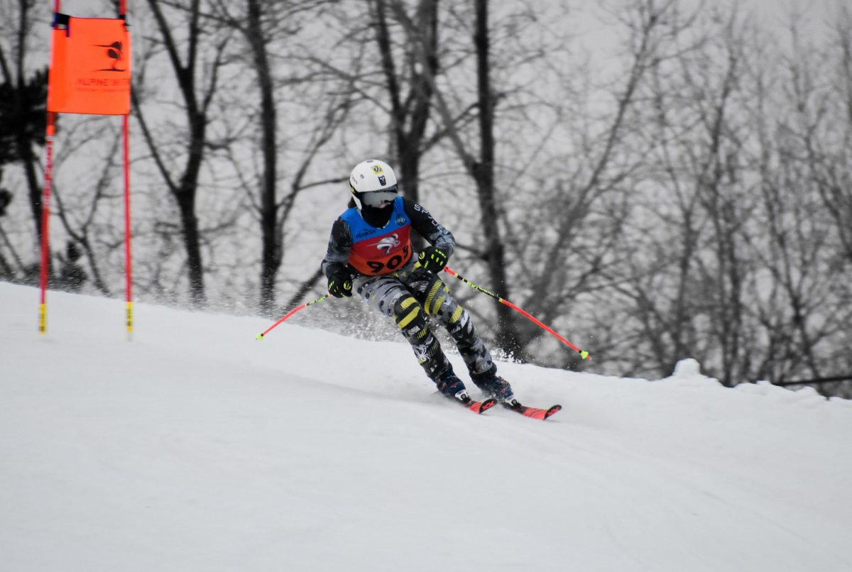 Focused on the gate, freshman Conor Jernigan races down the hill. On Jan. 7, the Alpine Ski team competed against Grand Blanc losing by two.