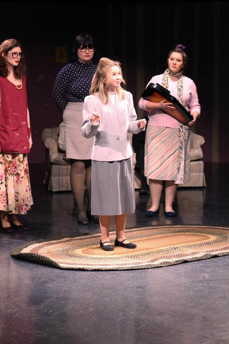 Speaking to the crowd, junior Macie Dunkel plays her part. On Jan. 8, the play "Who's Crazy Now" was held in the Black Box. 