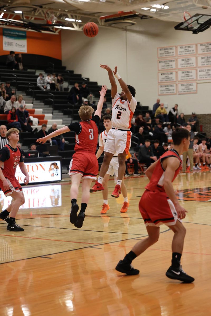 Shooting the ball, junior Jakyi Brown-Abston goes for a jumper. On Jan. 9, the Fenton varsity basketball team went up against Linden. (find score later)