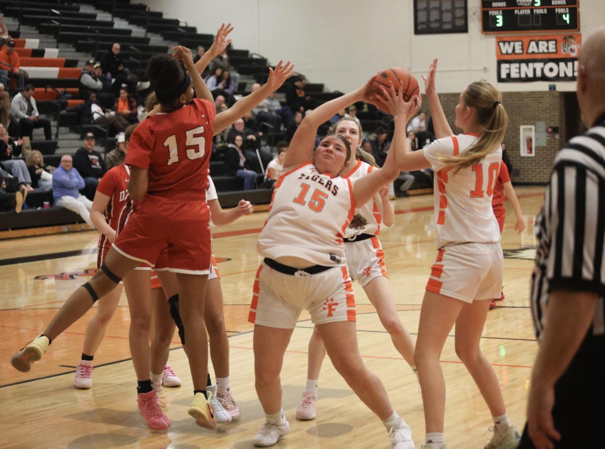 Catching the ball, senior Alivia D’alimonte attempts to make a basket. On Jan. 23, the Fenton varsity basketball team played Swartz Creek and won 50-30.

