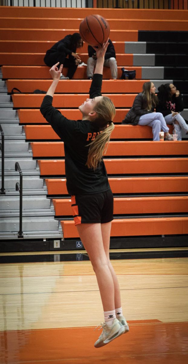 Shooting the ball, sophomore Charlei Peabody attempts to make a layup. On Jan. 16, the varsity girls had a game against Flushing and won 37-36.