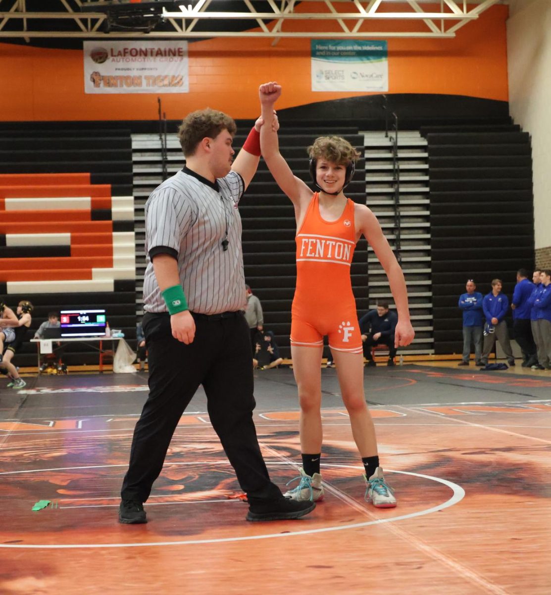Celebrating the win, freshman Jacob Harper wrestled his opponent. On Jan 10, Fenton Wrestling competes in a tournament against five different schools.