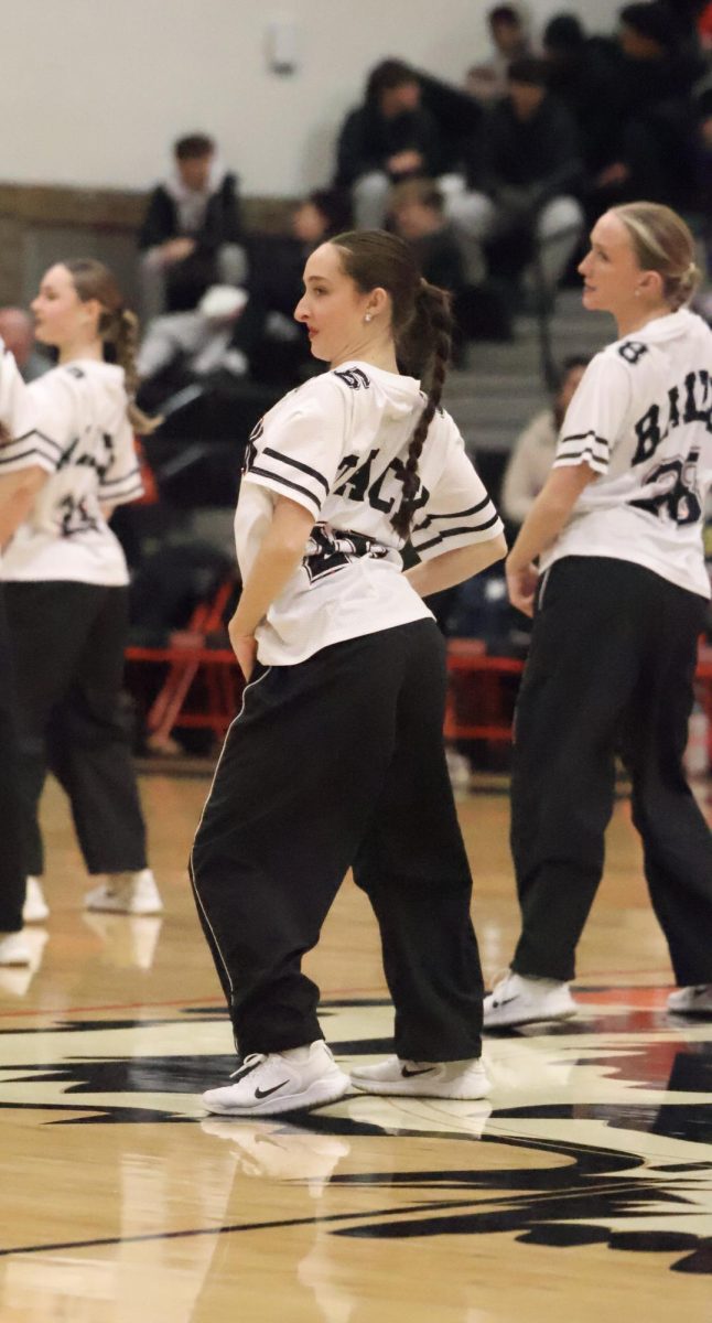 Dancing to the beat, senior Sanibel Stack is posing. On Sept 19, the Fenton dance team performed at halftime of the basketball games.
