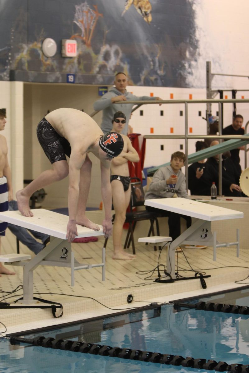 Preparing to start, senior Jack Todorovsky takes his mark for his race. On Jan. 21, the Fenton Swim and Dive team had a meet against Walled Lake Northern and Powers Catholic High.