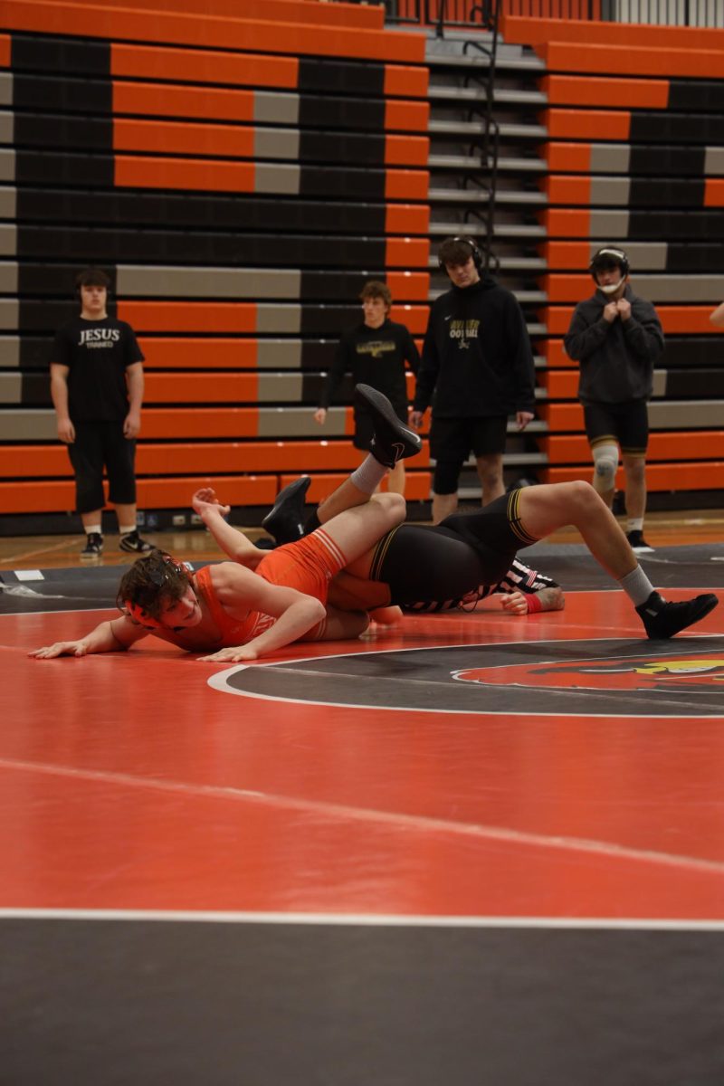 Pinning down to the mat, freshman Jayden Hawks puts his opponent into a leg cradle. On Jan. 28, Fenton wrestling has a meet against Corunna.